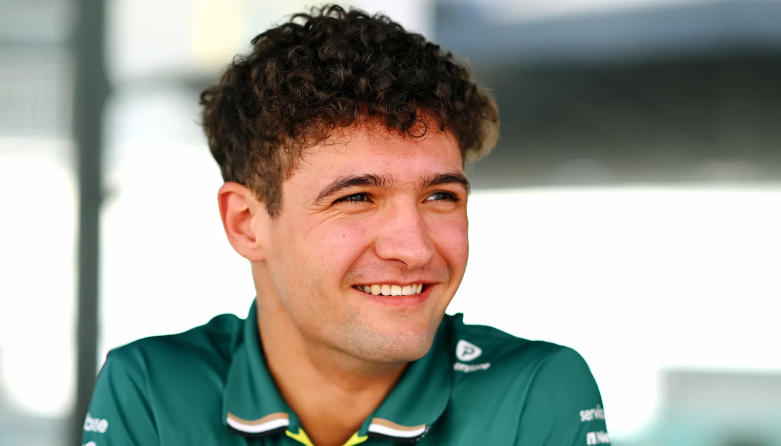 Jak Crawford smiling in Aston Martin team clothing