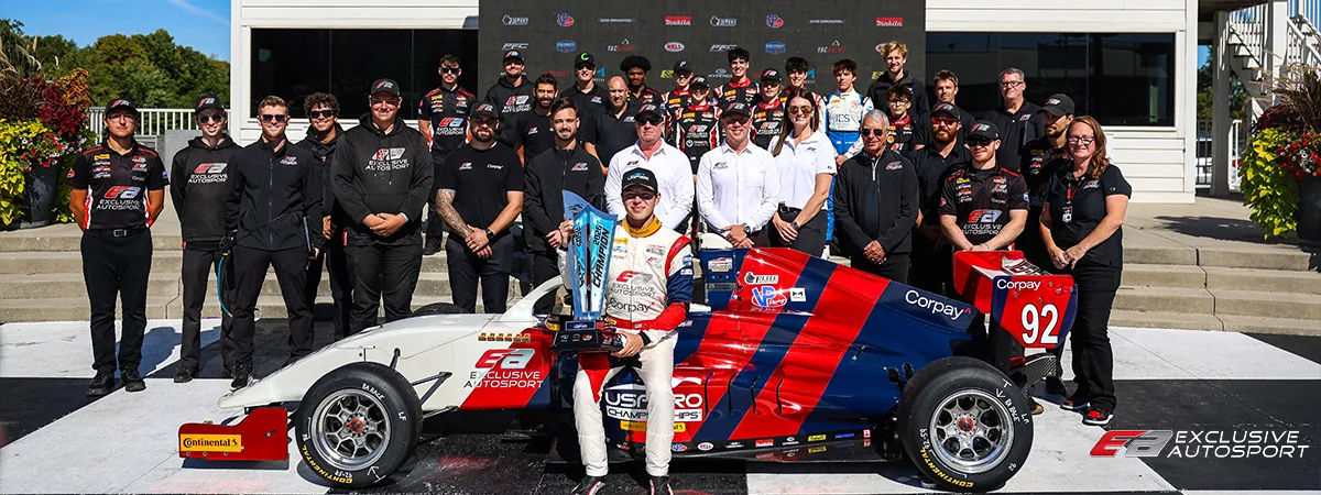 USF Pro 2000 driver and team celebrating beside the race car